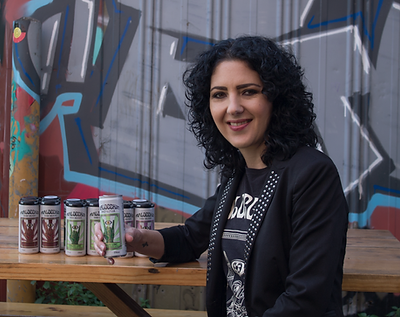 Malocchio Drinks co-founder Anna Chiera pictured with Malocchio Hard Seltzer Black Cherry, Finger Lime and Kakadu Plum.