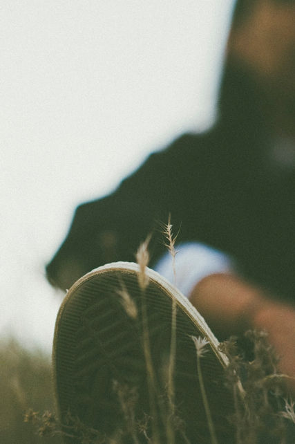 Close-up of bottom of shoe, with man in the background