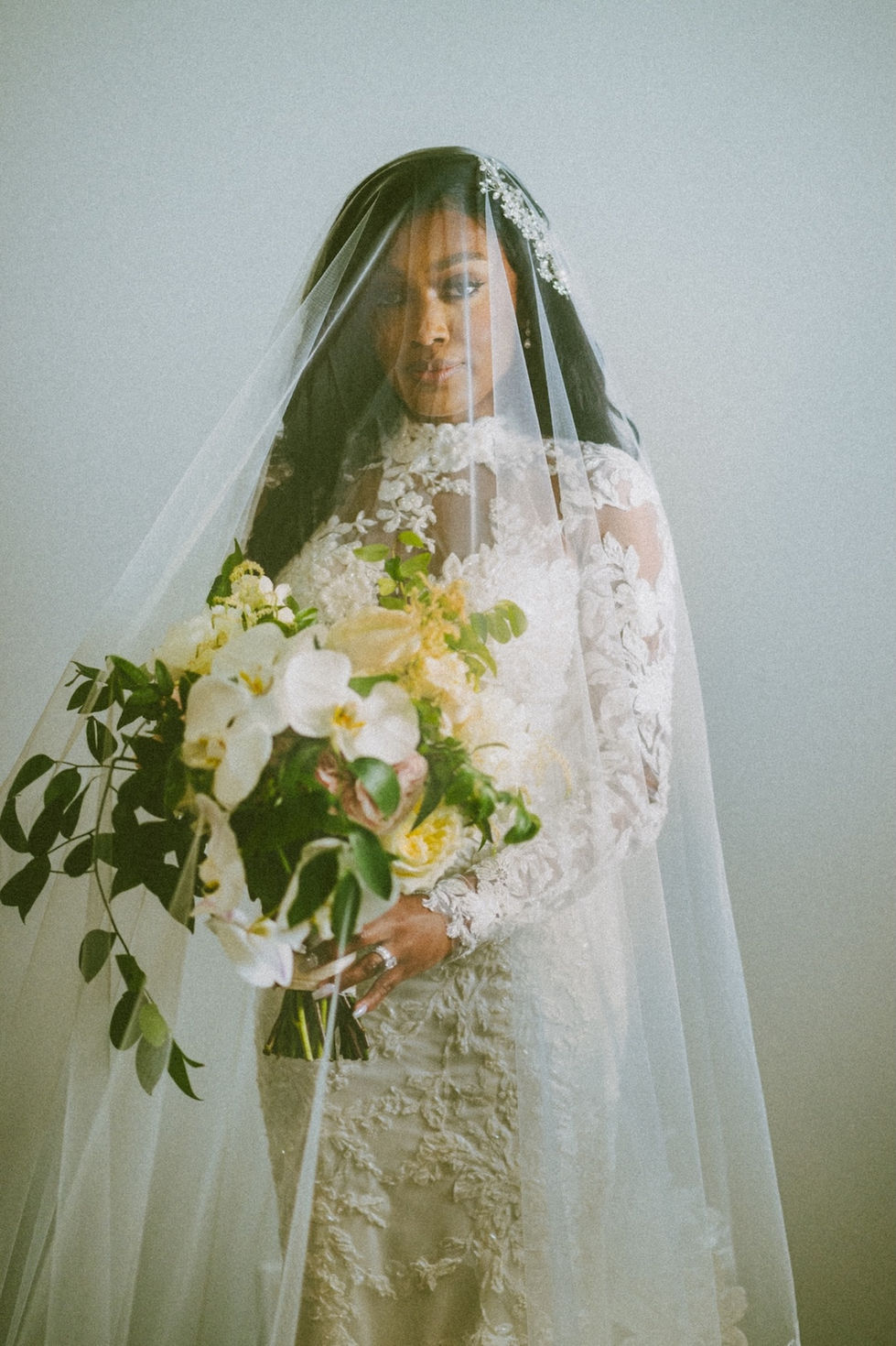 bride holding bouquet with veil c