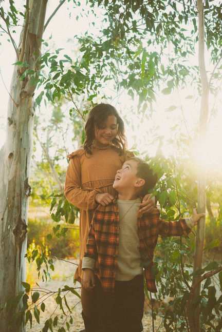 Brother and sister smiling at each other