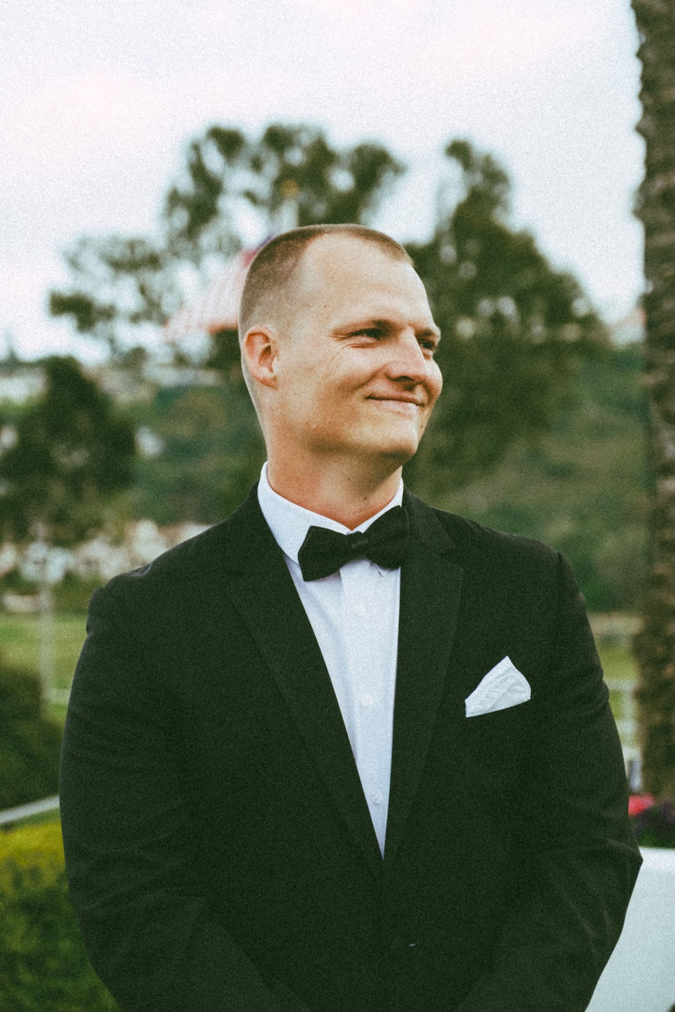 Groom looking at bride walking up the aisle