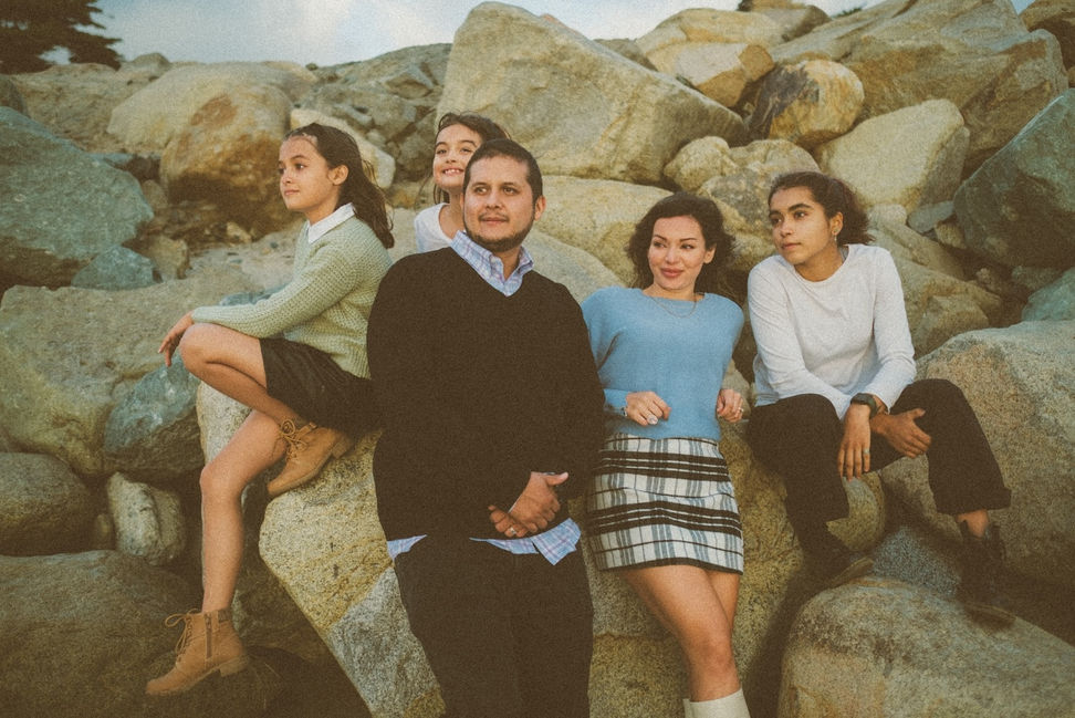 Family poses for pictures at the beach