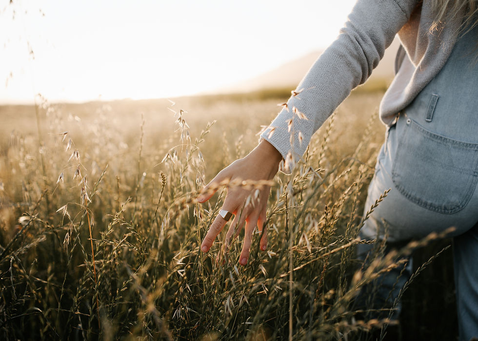 Woman walking through tall grass in nature