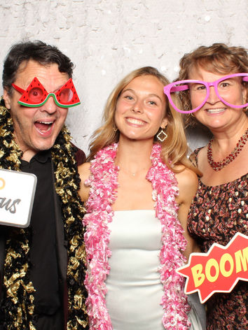 Wedding guests posing with photo booth props at a Raleigh area event
