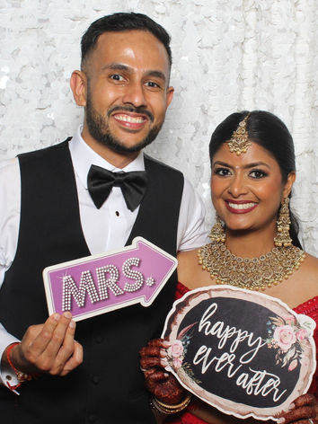 Wedding couple having fun with photo booth props in Raleigh NC