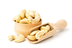 cashew-wooden-plate-spoon-white-surface-close-up_269543-448