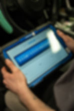 Picture of a top don vehicle scanner with two hands holding in a vehice