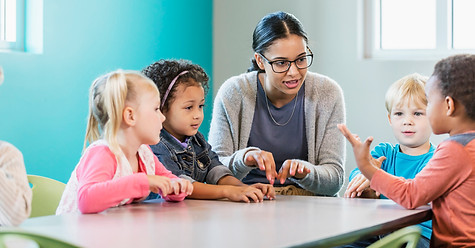 Dedicated teacher at The SMLLL Academy actively engaging with her students, fostering a positive and interactive learning environment in our private school setting.