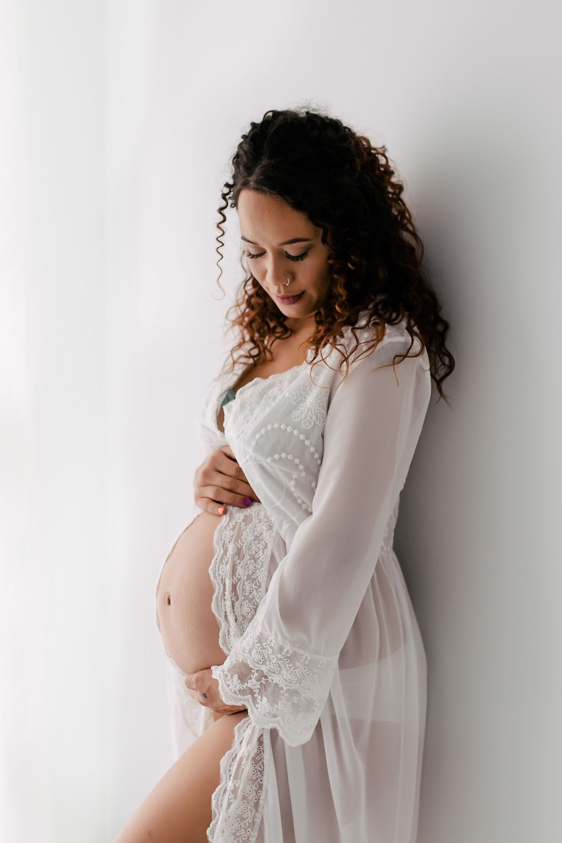 Pregnant woman in lace sheer robe