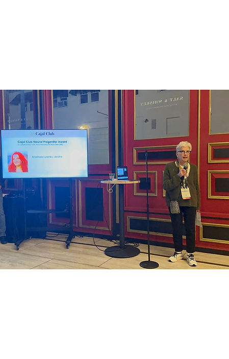 This is a portrait of Carol Mason announcing the winners of the International Brain Bee Awards.