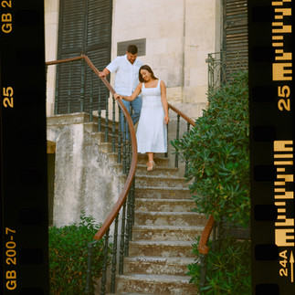Couple embracing in front of a stone doorway during a corfu analog film wedding.