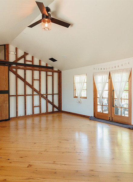 Light, airy, and open yoga studio with wood floors