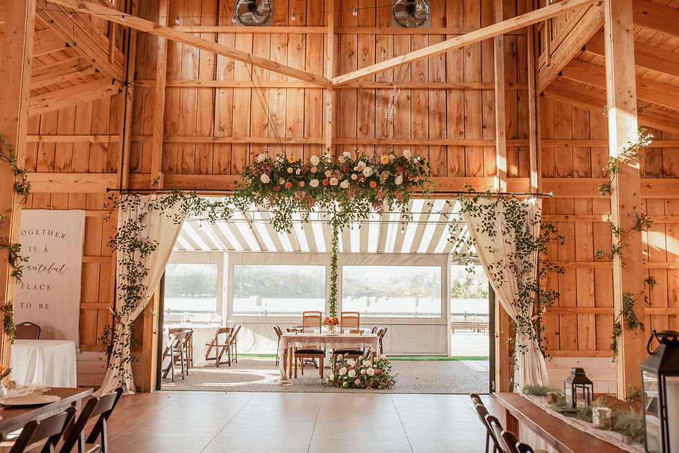 Wide angle view of rustic barn surrounded by lush greenery
