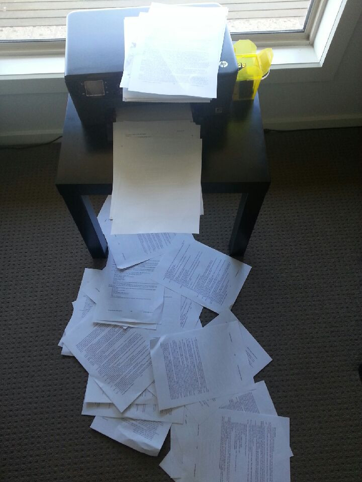 Life. Sometimes it's like this. A photo of a printer with printed pages fallen across the floor.