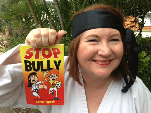 A photo of author Karen Tyrrell with her book