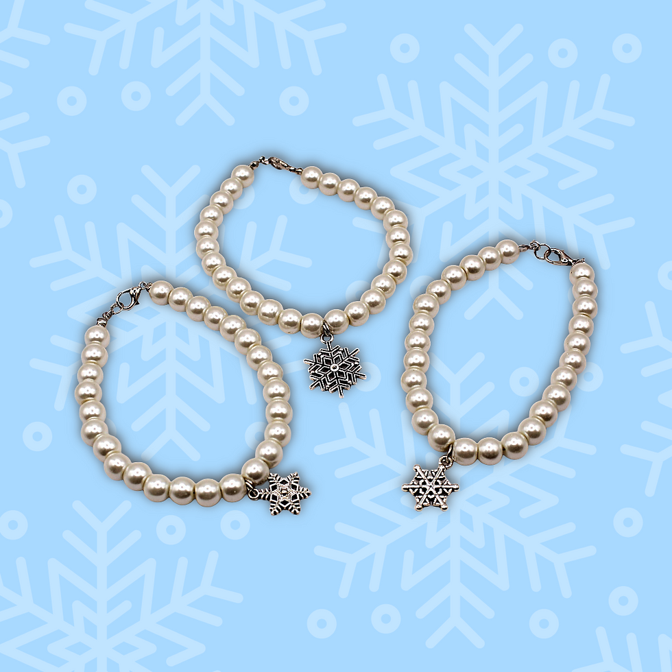 three faux pearl bracelets with snowflake pendants on a blue background