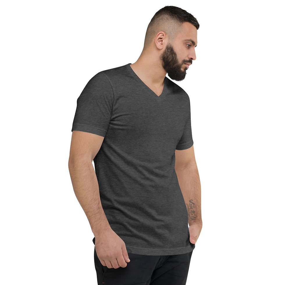 Thumbnail: Man in dark grey V-neck t-shirt with hands in pockets looking away.