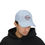 Thumbnail: Man wearing light blue Doxa Apparel hat with logo
