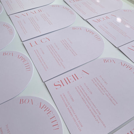 Pink arched wedding menus