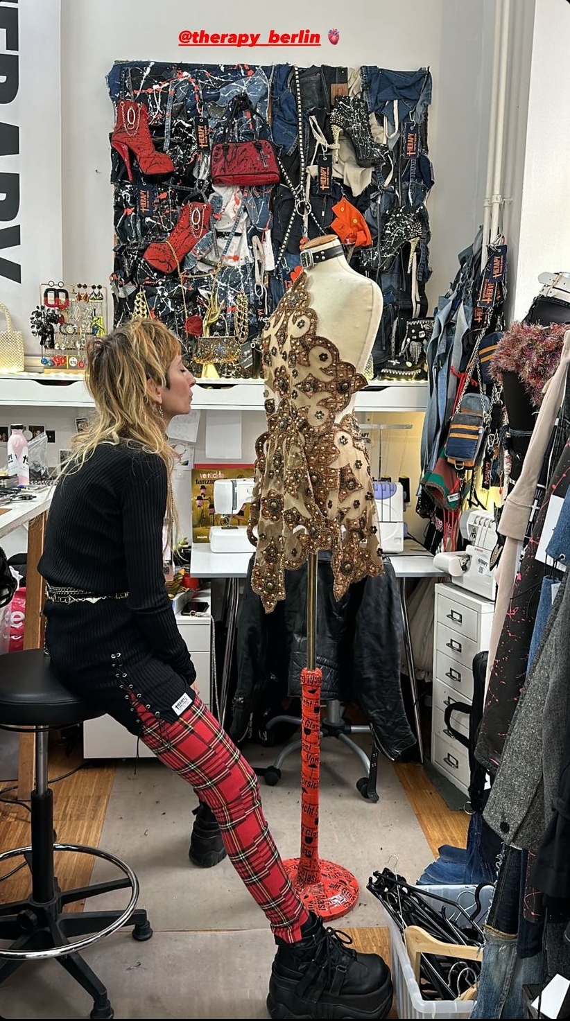 Angie in the therapy recycle and exorcise studio working on a dress