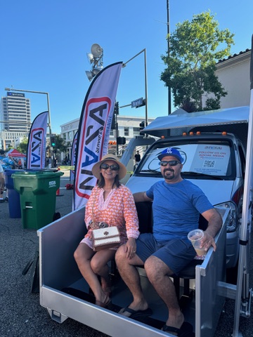 Guests sitting on the NASA Services truck bench at Glendale Cruise Night 2026