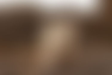 A couple eloping in Moab UT walks toward a red cliff at sunset