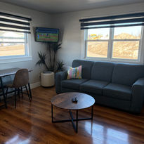 This room features a queen bed to sleep 1-2 people, a queen sized sofa bed to sleep an additional 1-2 people, a small kitchenette, TV, and private bathroom.