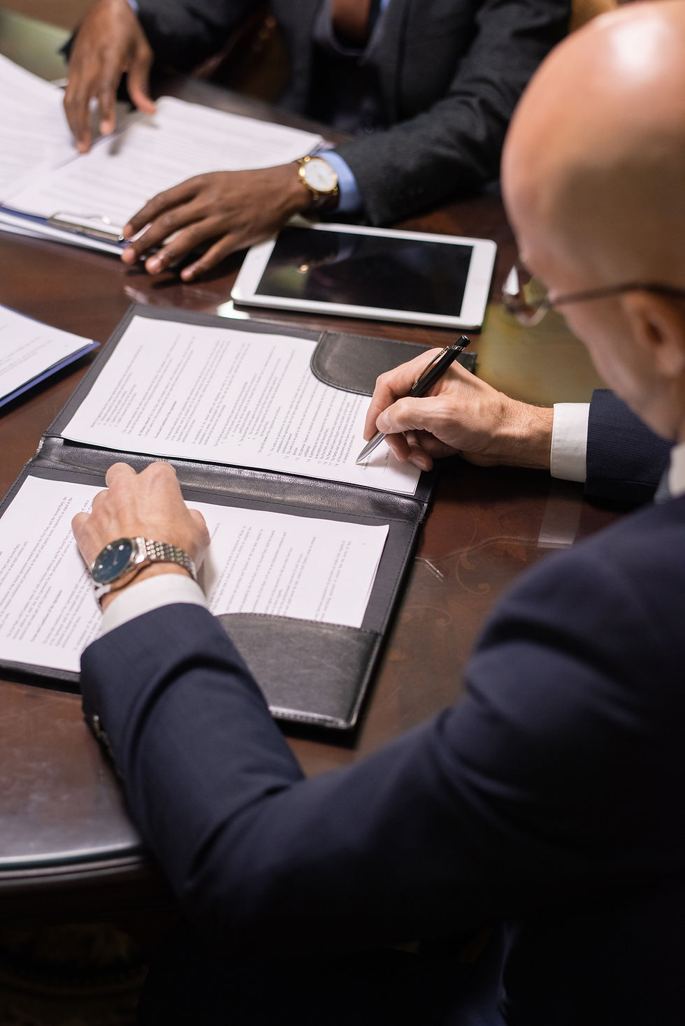 mature businessman putting his signature on juridiction