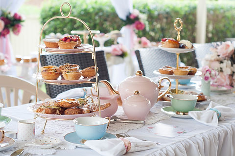 Pastel high tea set up featuring pastel pink, blue, yellow and green Royal Doulton tea set
