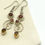 Thumbnail: Silver Tone Swirl Dangle Earrings with Gold Stone & Amber Glass Stones