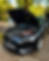 Black car with hood open for roadside assistance