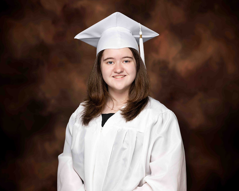 Student in white graduation cap and gown.