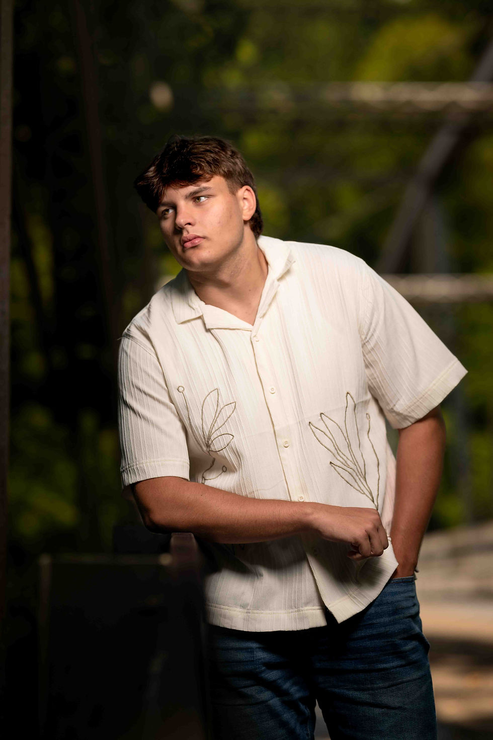 Young man posing for a school portrait outdoors