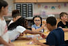 Students playing a board game together in a classroom.