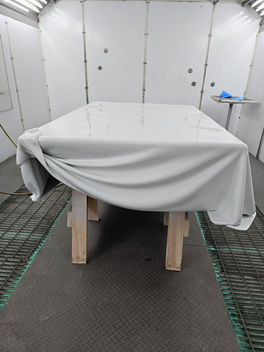 The resin table in the finishing booth with its white surface.
