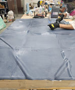 A close view of the tabletop and its subtle folds during surface preparation.