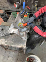 Handheld abrasive tools refine the steel surface before the final polish.
