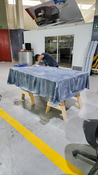 The tabletop and sides receive further surface preparation before entering the finishing booth.