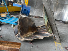 The chair’s bronze sections during assembly, before the surface is resolved into its final finish.