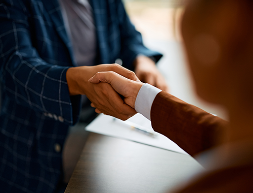 Business handshake between two professionals in suits