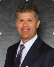 Smiling male team member in a suit and tie