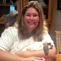 Shannon with her family's bunny, African Gray parrot, and Gread Dane Zeus. Owner of Ocala pet Sitting