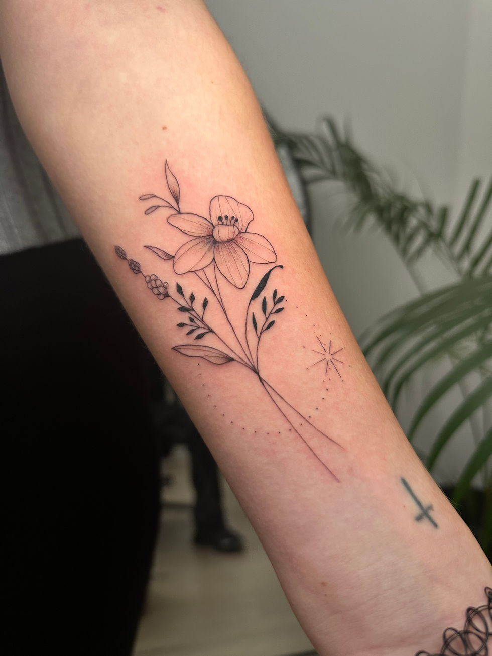 a woman has a tattoo of a flower on her forearm