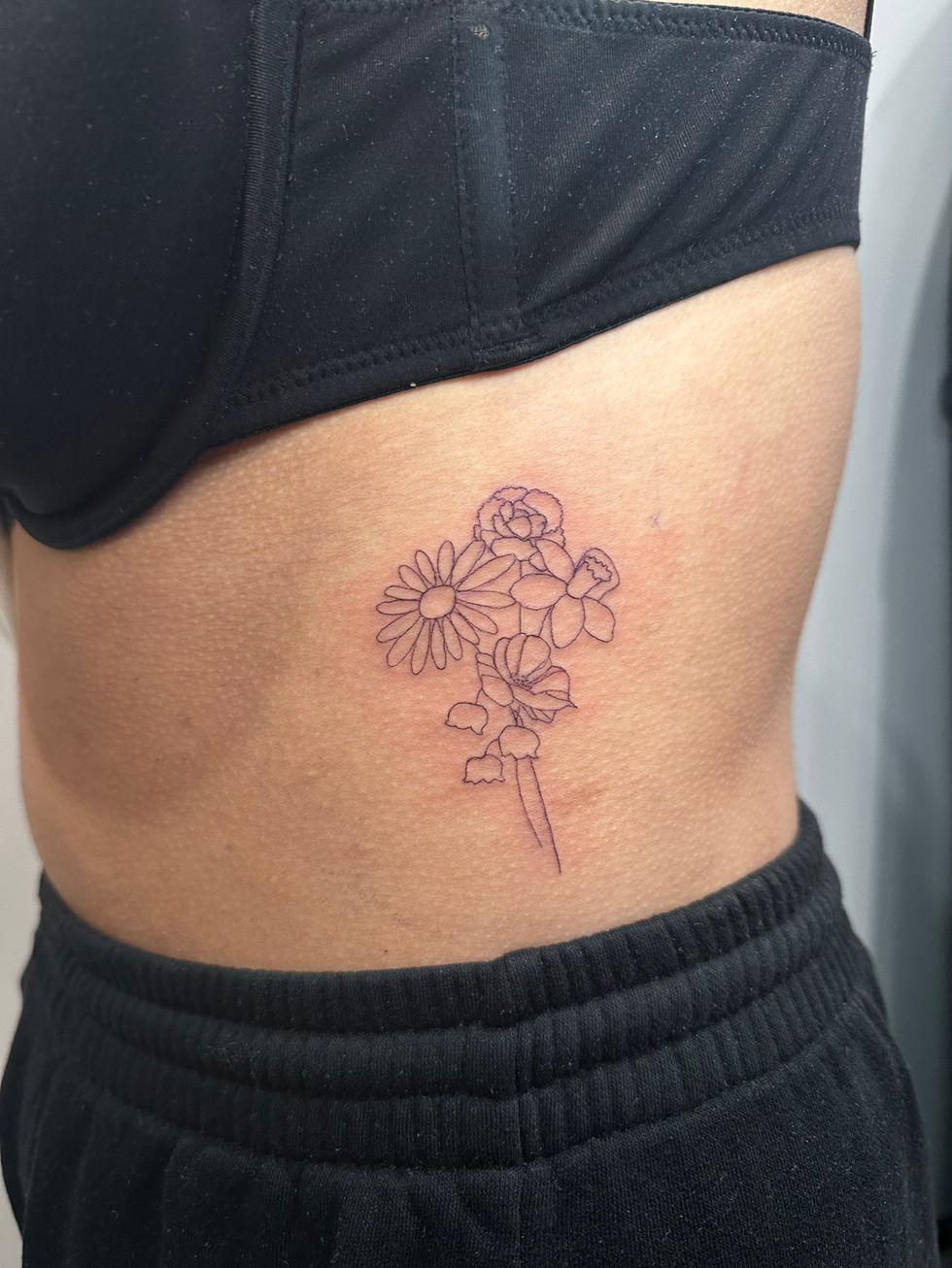 a woman has a tattoo of flowers on her side