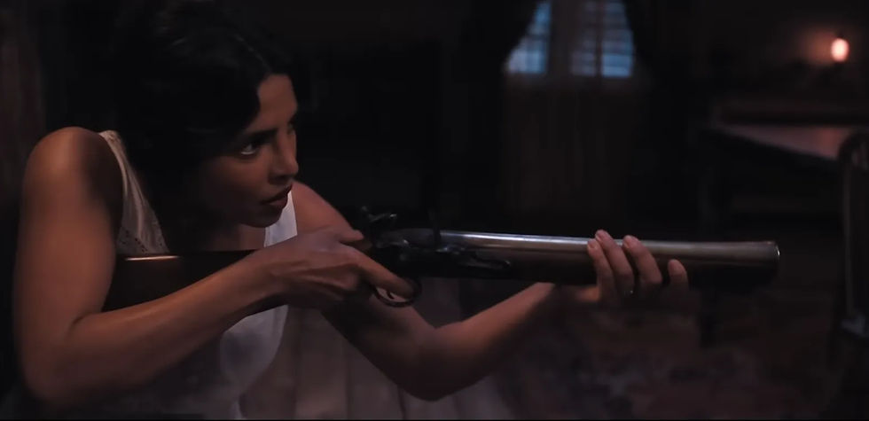 Priyanka plays Urscel holding a blunder buss gun