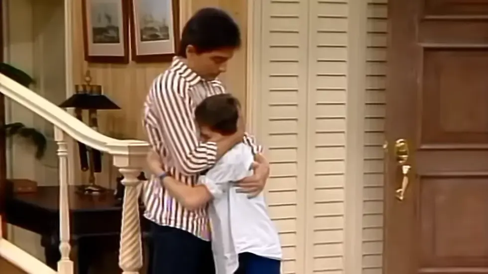 Scott Baio as Charles comforting on of the kids