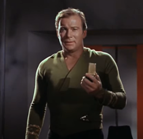 William Shatner as Captain Kirk using a Communicator