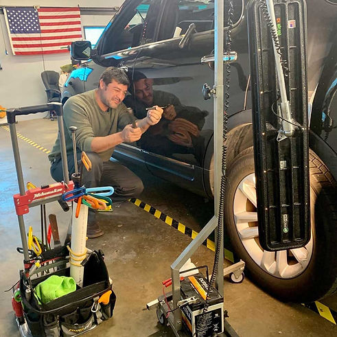Dallas-Dent-repair-tech-working-on-vehicle.jpg