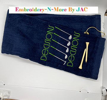 Navy blue trifold golf towel with hook.  Embroidered with decisions decisions and image of different clubs green embroidery