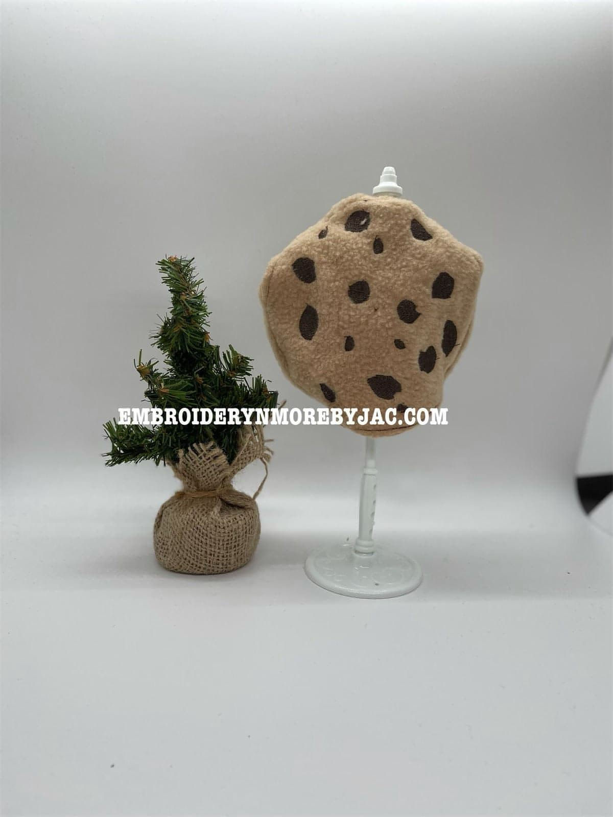 chocolate chip cookie costume for the elf. there is also a decorative christmas tree in the picture